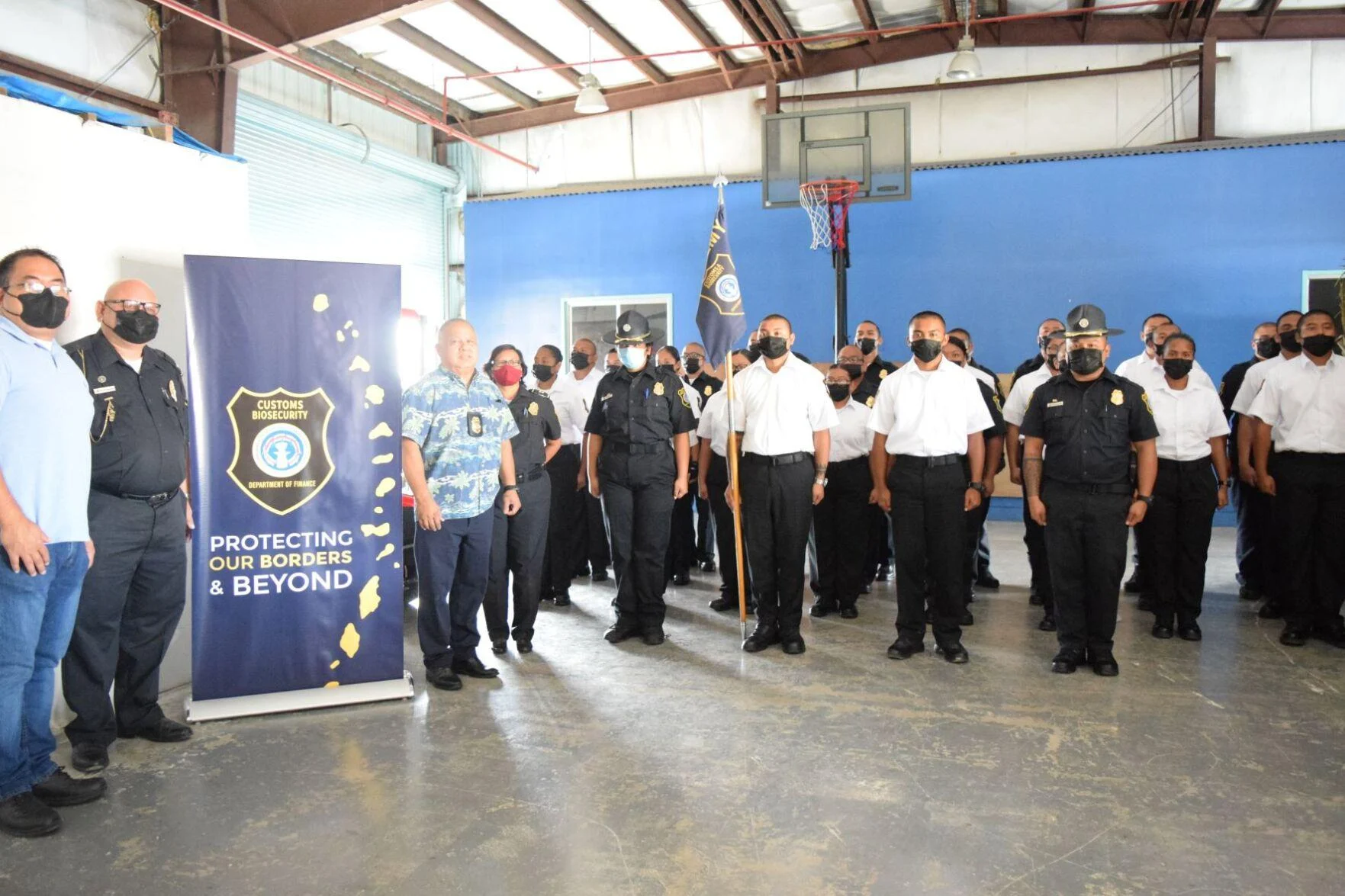 Customs and Quarantine Director Jose Mafnas, third left, Northern Marianas College Criminal Justice Department chair Clement R. Bermudes, left, Special Assistant for Customs Enforcement Col. James C. Deleon Guerrero, second left, and Customs Capt. Reina Camacho join the First Cycle cadets of the Customs and Biosecurity Academy at the Customs Seaport Warehouse on Monday. Photo by Emmanuel T. Erediano