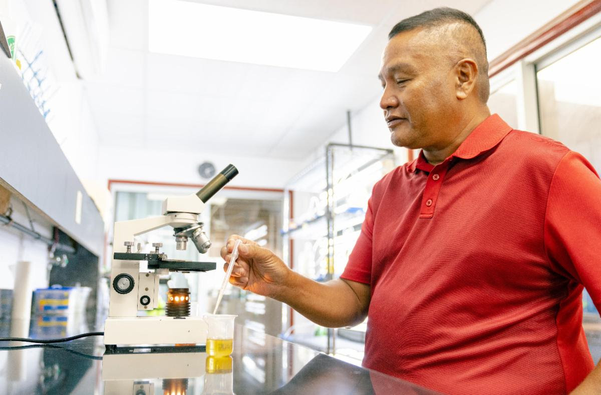 Northern Marianas College, Cooperative Research, Extension, and Education Services (CREES) — Aquaculture and Natural Resources Program Leader, Michael Ogo prepares to look at Phytoplankton in the Aquaculture Laboratory at the NMC As Terlaje Campus. The Aquaculture and Natural Resource program of NMC-CREES was recently awarded $536,000 to construct mangrove crab (Scylla serrata) farming demonstration units on the islands of Saipan, Tinian, and Rota.